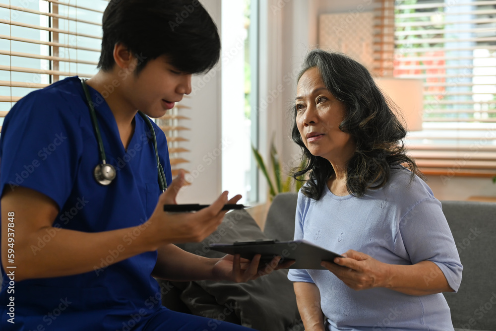 Head shot general practitioner doctor in blue uniform giving consultation to senior female patient. Healthcare and assistance concept Head shot general practitioner doctor in blue uniform giving consultation to senior female patient. Healthcare and assistance concept