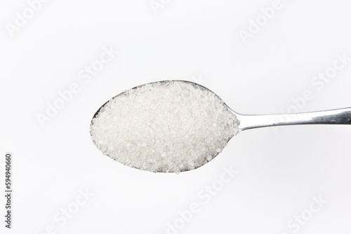 with sugar in spoon isolated on white background