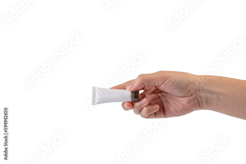 Female hand holds cosmetic product in tube, bottle, lotion or serum on transparent background.