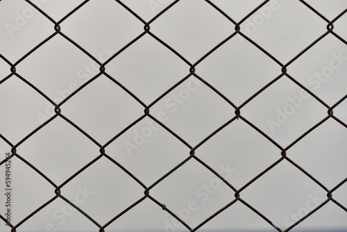 Closeup of rusty wall grid with gray background