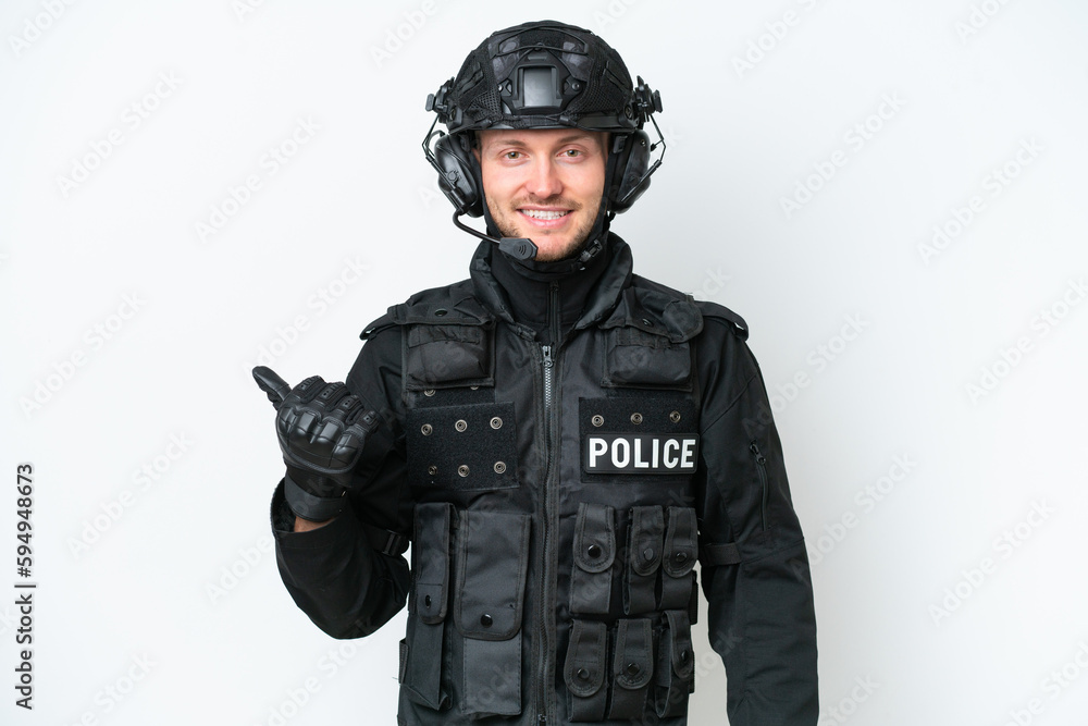 SWAT man over isolated white background pointing to the side to present a product SWAT man over isolated white background pointing to the side to present a product