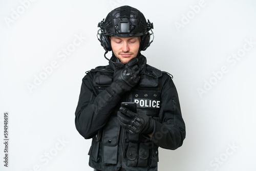 SWAT man over isolated white background thinking and sending a message © luismolinero