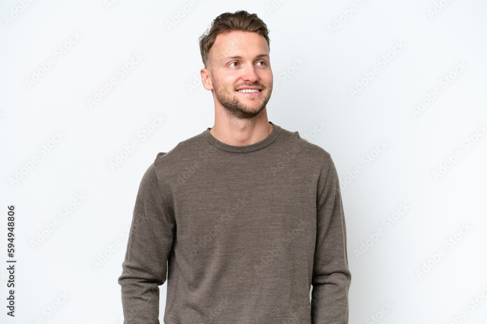 Young blonde caucasian man isolated on white background thinking an idea while looking up Young blonde caucasian man isolated on white background thinking an idea while looking up