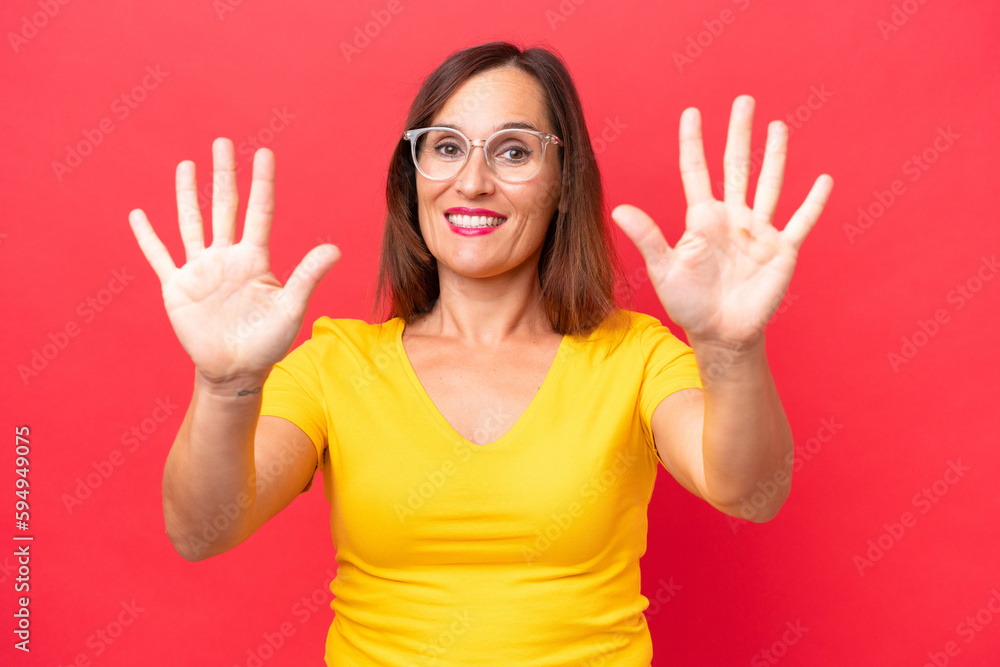 Middle-aged caucasian woman isolated on red background counting ten with fingers Middle-aged caucasian woman isolated on red background counting ten with fingers