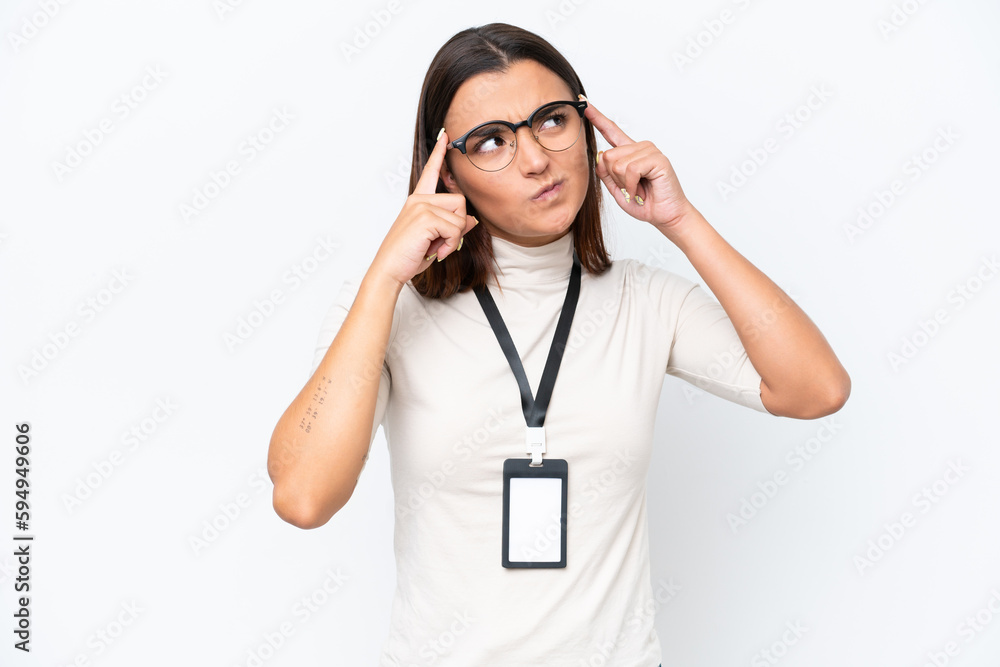 Young caucasian woman with ID card isolated on white background having doubts and thinking Young caucasian woman with ID card isolated on white background having doubts and thinking