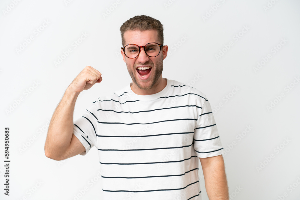 Young handsome caucasian man isolated on white background celebrating a victory Young handsome caucasian man isolated on white background celebrating a victory