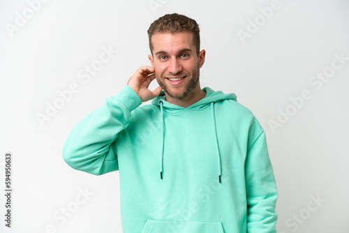 Young handsome caucasian man isolated on white background laughing © luismolinero