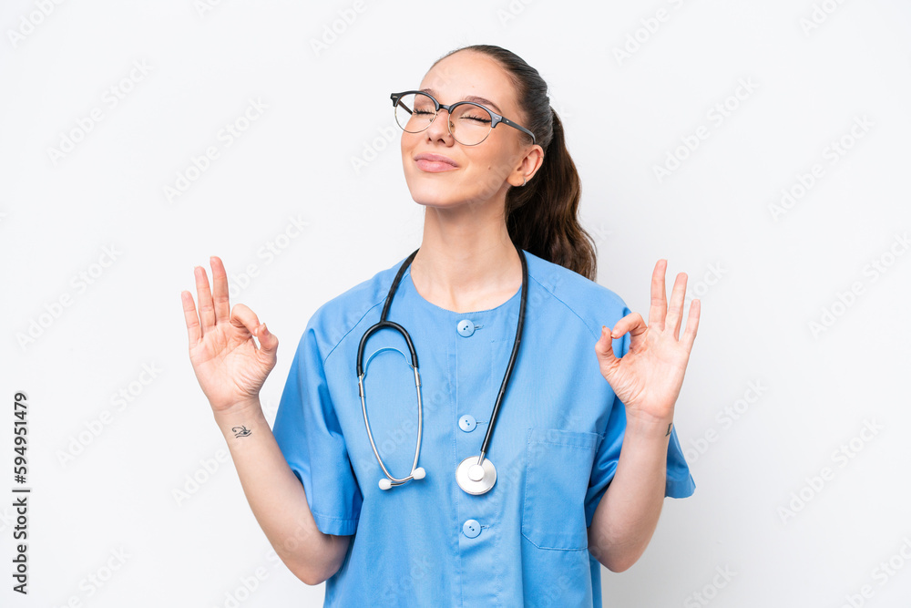 Young caucasian surgeon doctor woman isolated on white background in zen pose Young caucasian surgeon doctor woman isolated on white background in zen pose