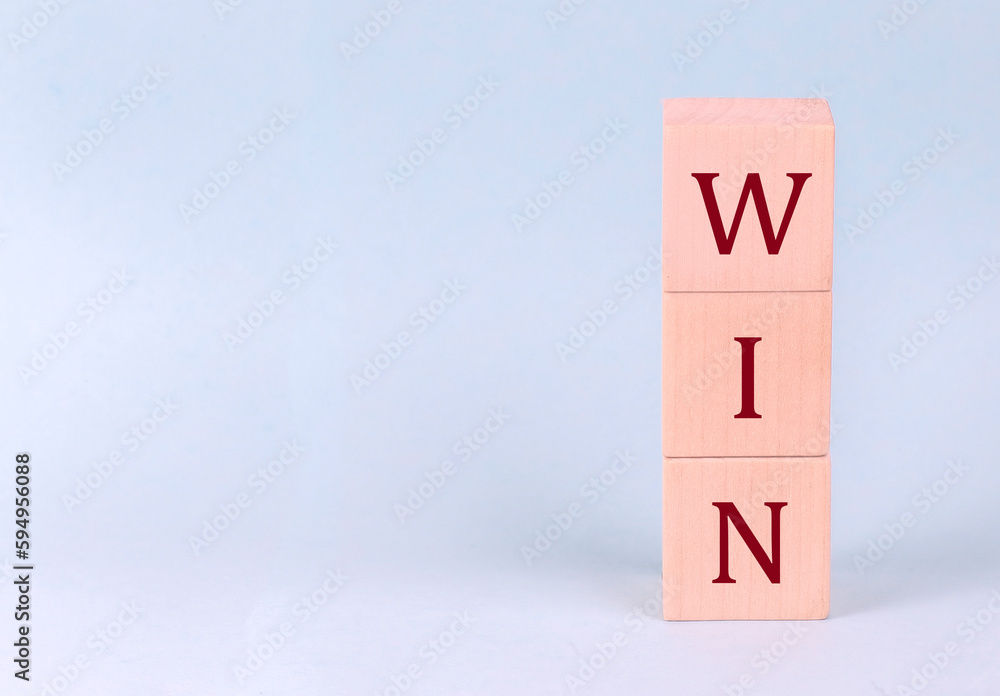 WIN on wooden cubes on a blue background WIN on wooden cubes on a blue background