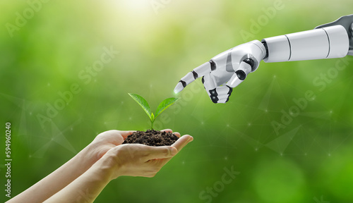 environment Earth Day. Hands holding trees growing with a robotic hand touching the tree collaboration between humans and technology to protect the environment together. Environmental technology.SDGs.