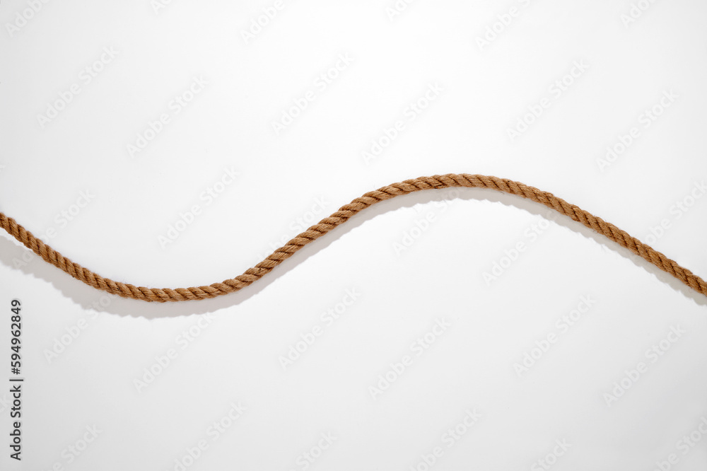 Natural fiber wavy rope with shadow on white background Natural fiber wavy rope with shadow on white background