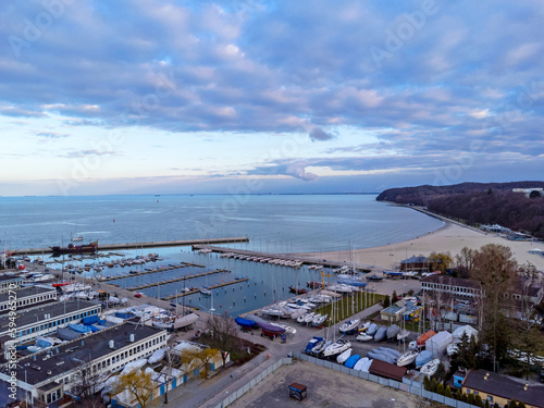 Obraz na płótnie Aerial view landscape Poland Gdynia. Port with sailboats , view of beach and sea. Colorful sky. w salonie