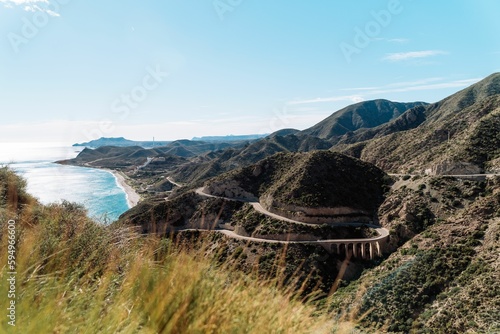 a mountain road and the ocean in the distance from cape point to corfa photo