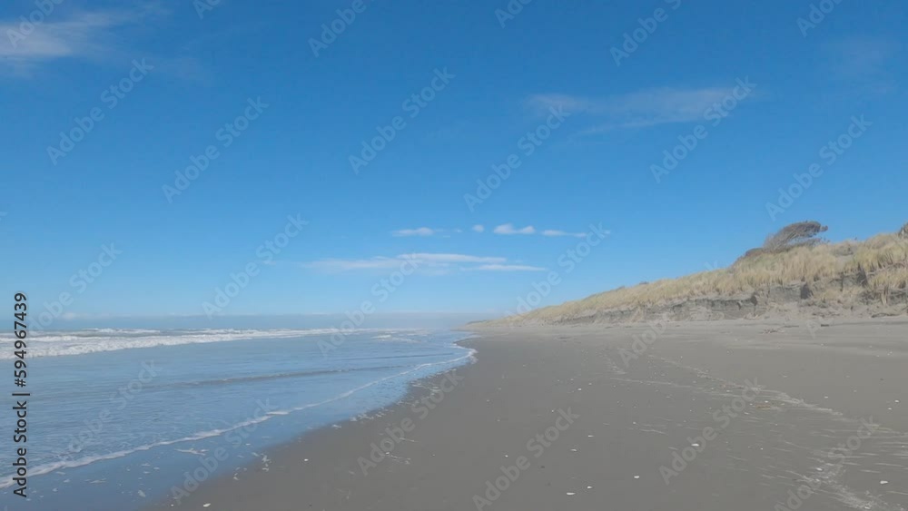 POV cycling on beach sand at high-tide as small waves roll in - Pegasus Bay, New Zealand POV cycling on beach sand at high-tide as small waves roll in - Pegasus Bay, New Zealand
