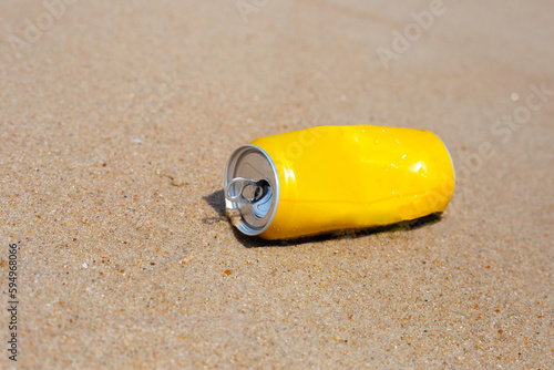 Yellow can waste on the beach