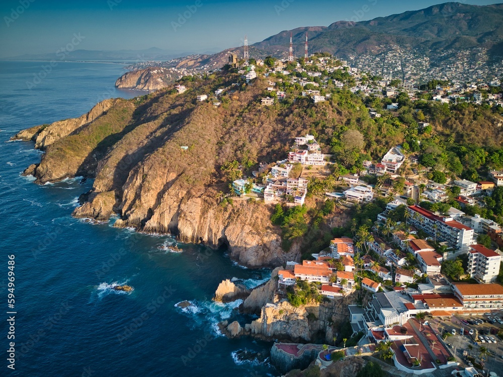 Aerial of cliffs in Acapulco skyline surrounded by the beach and the sea