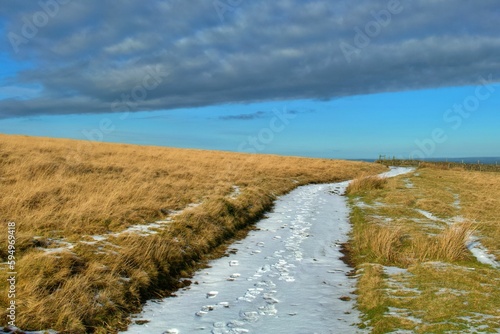 Picturesque winter scene featuring a snow-covered hill in Dartmoor National Park, UK