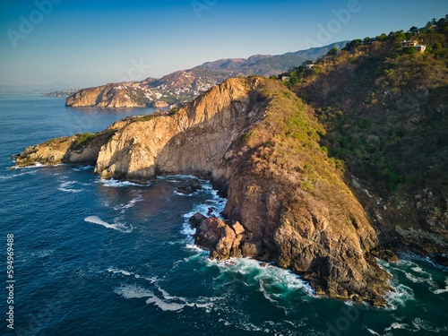 Aerial of cliffs in Acapulco skyline surrounded by the beach and the sea