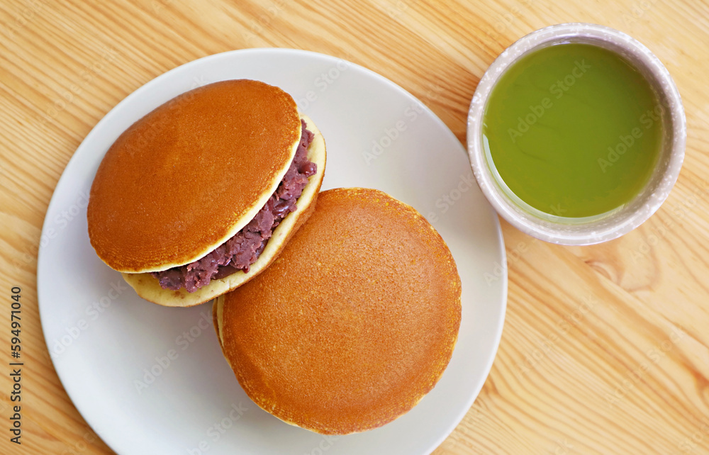 Top View of Delectable Dorayaki with a Cup of Hot Matcha Green Tea Top View of Delectable Dorayaki with a Cup of Hot Matcha Green Tea