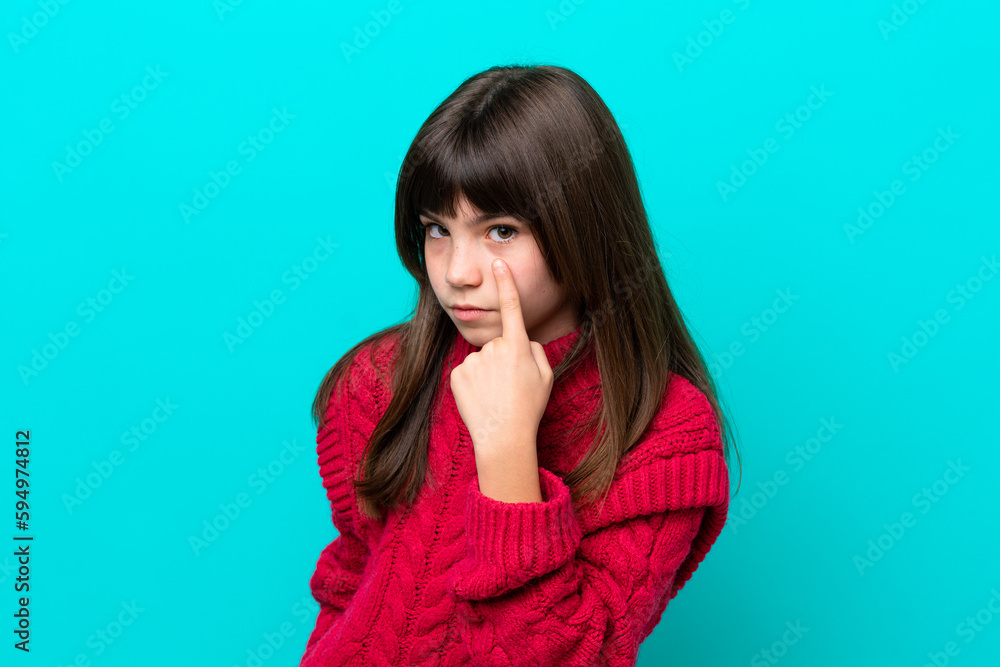Little caucasian girl isolated on blue background showing something Little caucasian girl isolated on blue background showing something