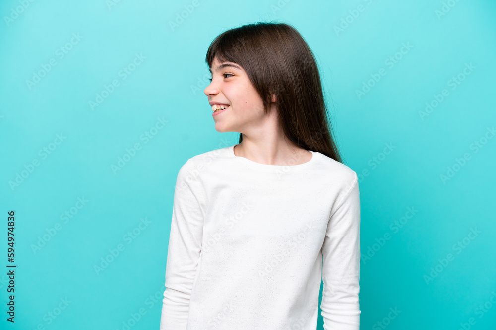 Little caucasian girl isolated on blue background looking side Little caucasian girl isolated on blue background looking side