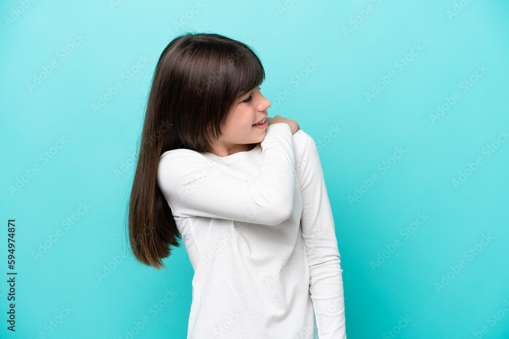 Little caucasian girl isolated on blue background suffering from pain in shoulder for having made an effort Little caucasian girl isolated on blue background suffering from pain in shoulder for having made an effort