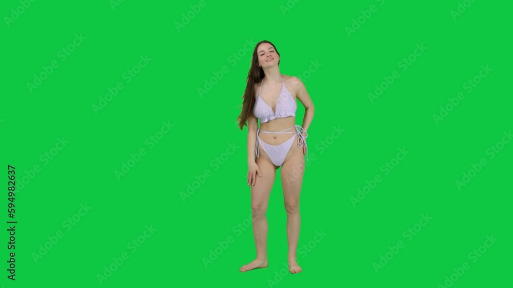 Happy and joyful female model posing in front of a green screen Happy and joyful female model posing in front of a green screen