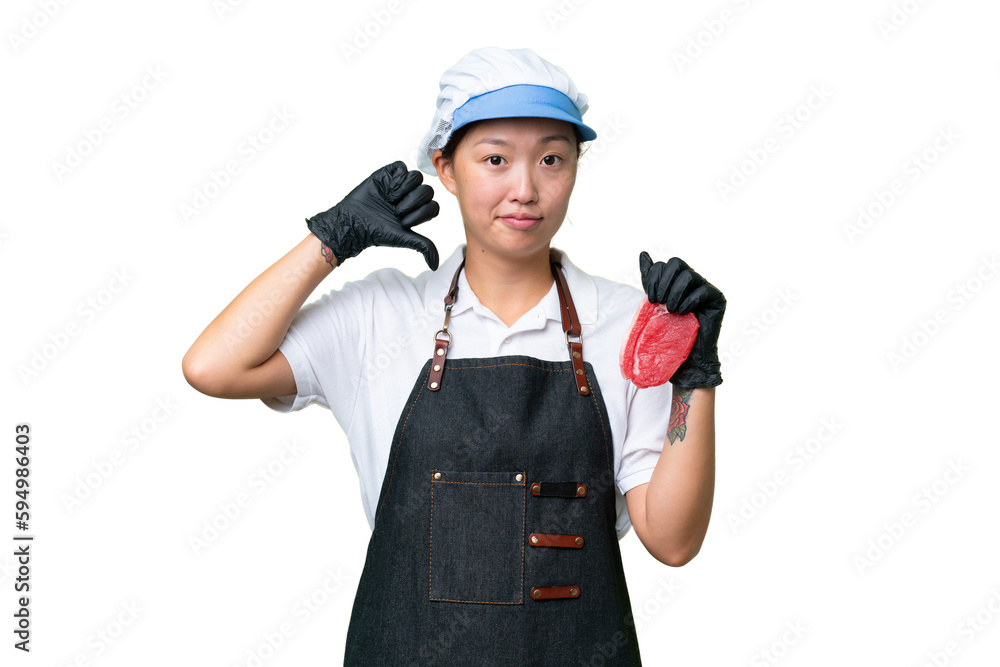 Young caucasian woman wearing an apron and serving fresh cut meat over isolated background showing thumb down with negative expression Young caucasian woman wearing an apron and serving fresh cut meat over isolated background showing thumb down with negative expression