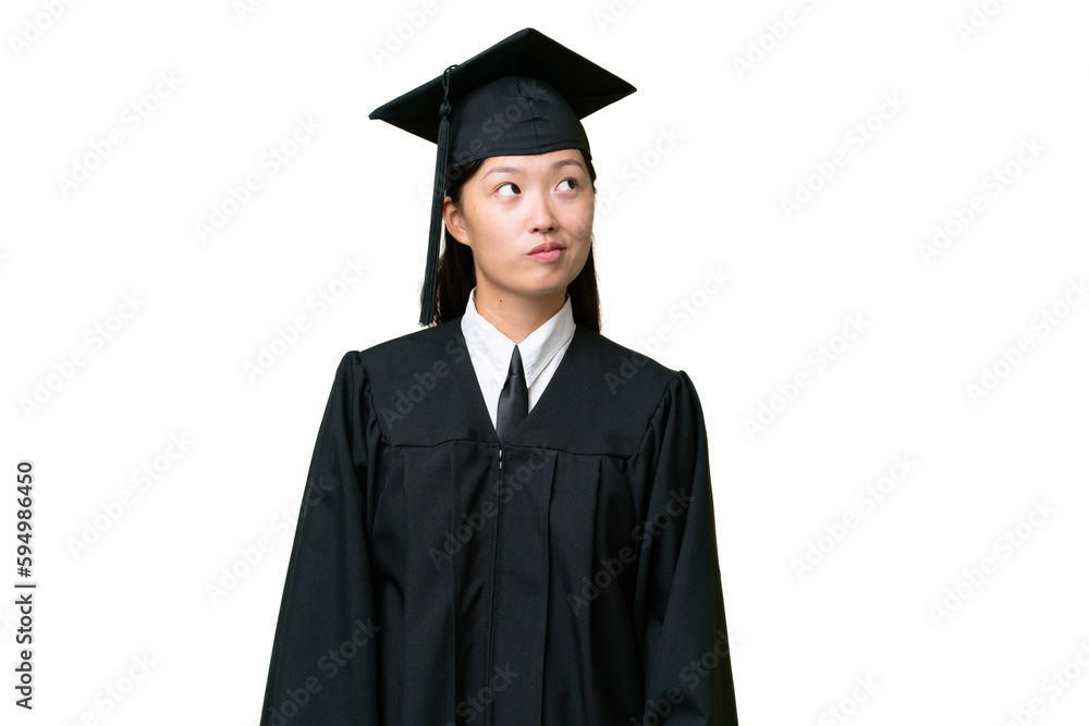 Young university graduate Asian woman over isolated background and looking up Young university graduate Asian woman over isolated background and looking up