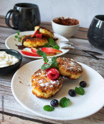 Delicious cheesecakes with berries and sour cream. Delicious breakfast. Morning