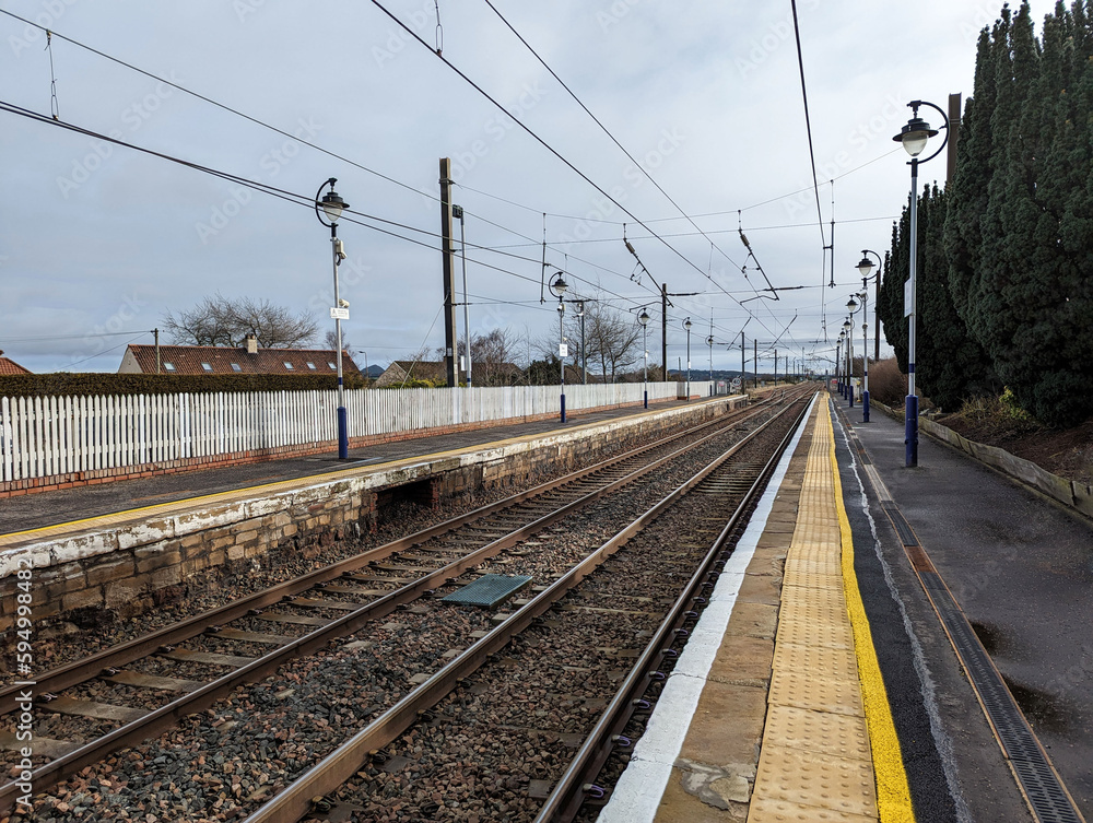  A view along the station platform and rails at Drem, East Lothian, Scotland, UK.
