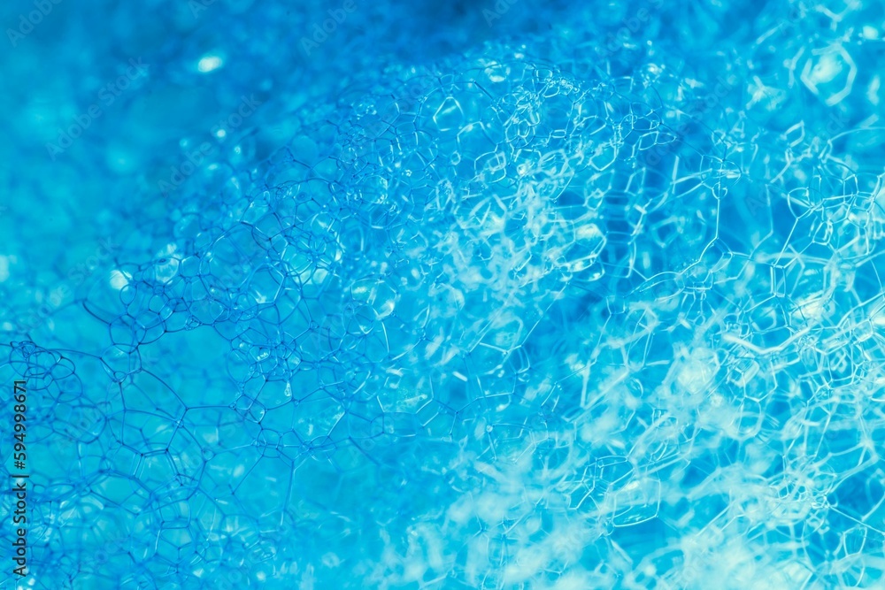 Closeup of blue translucent soap bubbles floating on the water surface, perfect for backgrounds Closeup of blue translucent soap bubbles floating on the water surface, perfect for backgrounds