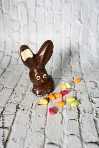 Close-up of a chocolate Easter bunny, filled with colorful candy and chocolate treats