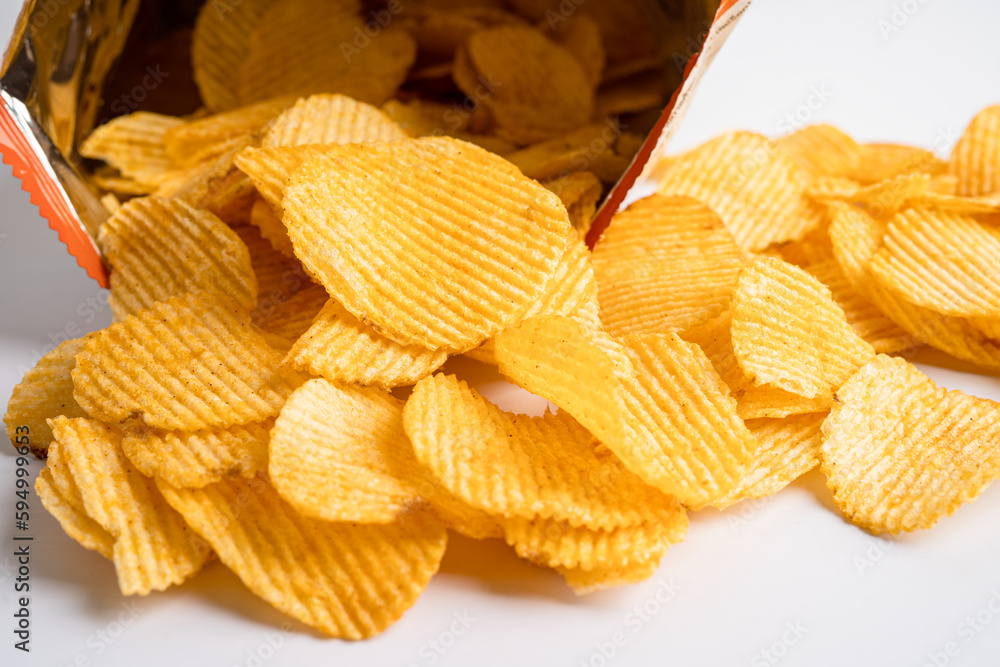 Potato chips, delicious BBQ seasoning spicy for crips, thin slice deep fried snack fast food in open bag. Potato chips, delicious BBQ seasoning spicy for crips, thin slice deep fried snack fast food in open bag.