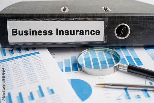 Business Insurance. Binder data finance report business with graph analysis in office.