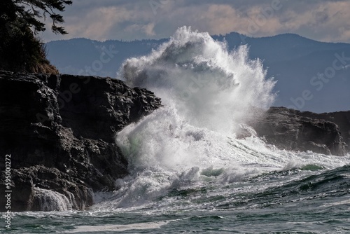 Majestic wave crashing on a rocky shoreline of sombrio point
