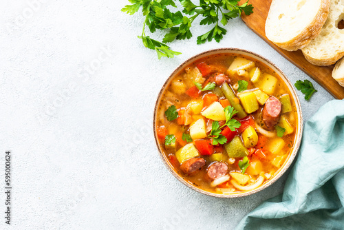 Minestrone soup, italian vegetable soup with smoked sausages, Top view.