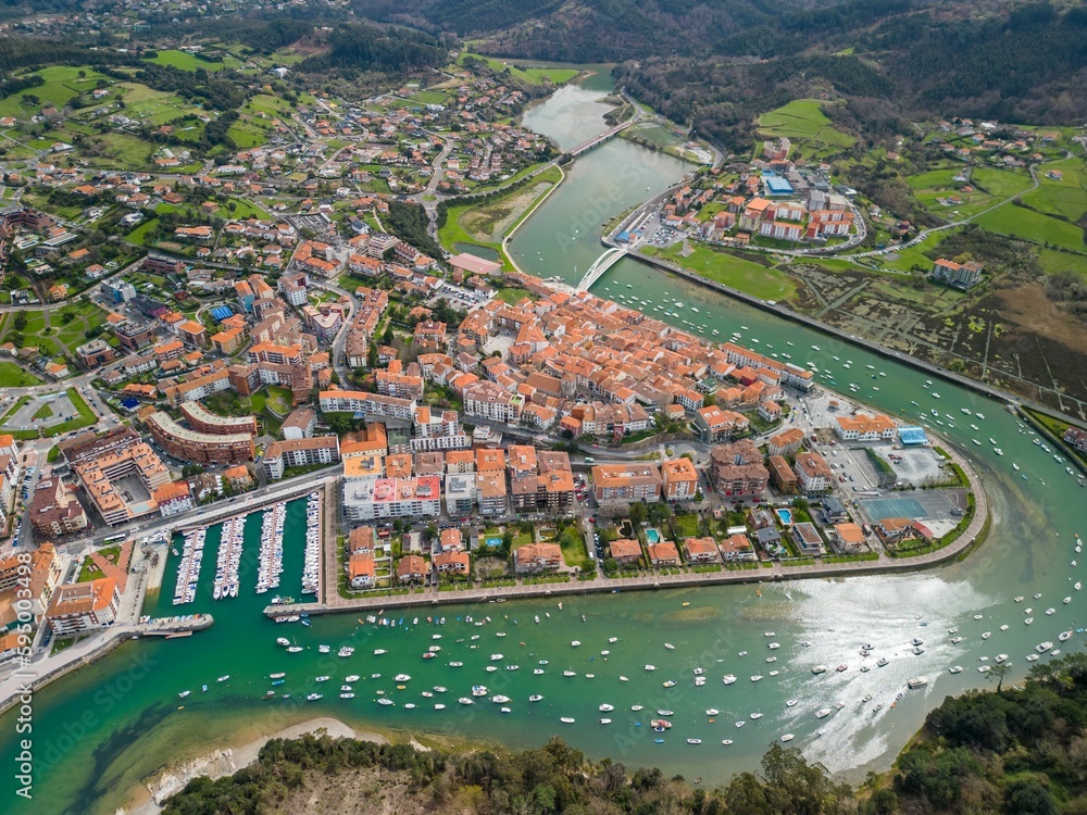 Idyllic rural landscape with a small village nestled on the banks of water in Basque Country