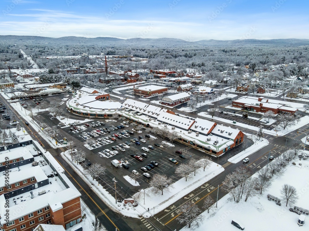 Fototapeta premium Aerial view of residential buildings and roads covered in the snow in Keene, New Hampshire
