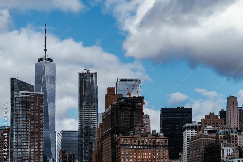 Cityscape of bustling New York city during daytime with a cloudy sky Cityscape of bustling New York city during daytime with a cloudy sky