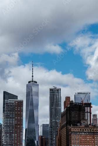 Cityscape of bustling New York city during daytime with a cloudy sky