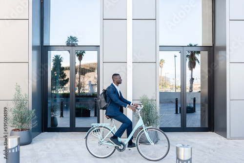 African American businessman with bicycle near modern building photo