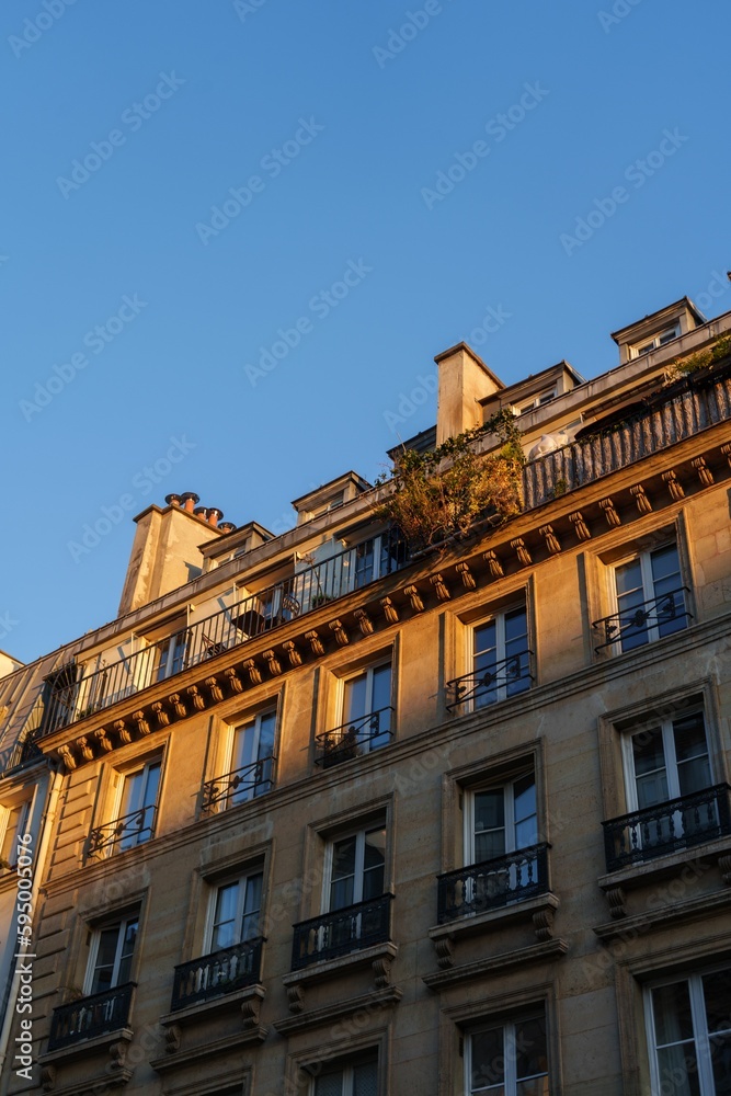 Apartment building with balconies lit in soft evening sunlight