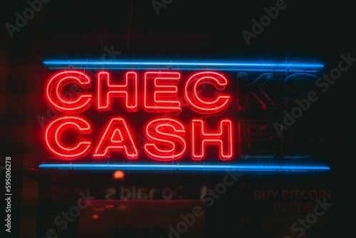 Sign brightly illuminated with a red neon glow at night