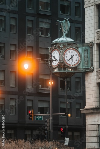 Ornate clock and statue are prominently displayed in front of a stately building in Chicago