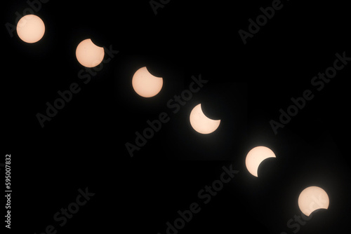 Solar eclipse hibrida phases on April 20, 2023. Cosmos with moon and sun in total and partial solar eclipse and stars.