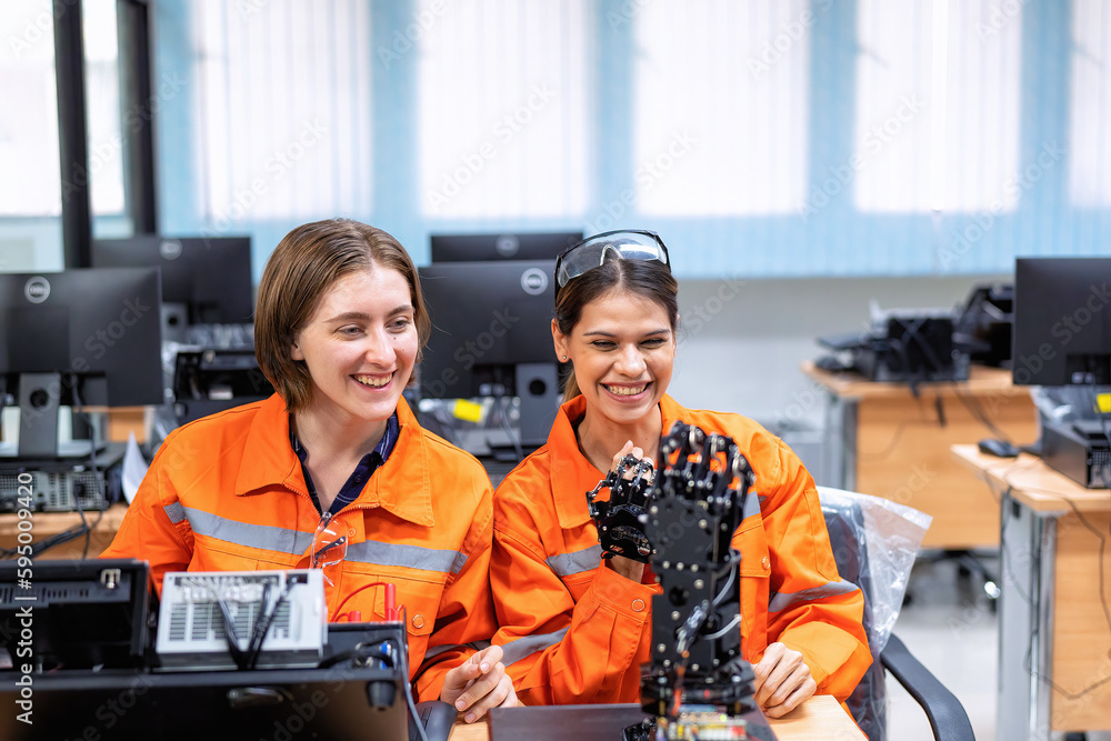 Girl engineer in robot industry fabrication research room simulate testing robot arm on operation Girl engineer in robot industry fabrication research room simulate testing robot arm on operation