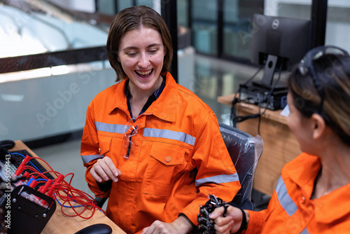 Girl engineer in robot industry fabrication research room simulate testing robot arm on operation