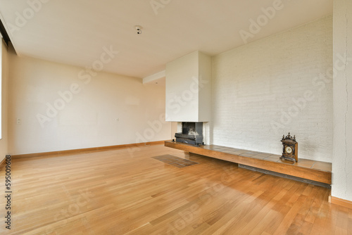 an empty living room with wood floor and white brick wall in the room is very clean, but there is no furniture