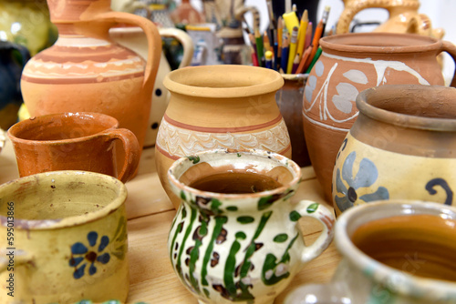 Billede på lærred Old traditional colored romanian handmade pottery displayed on a table